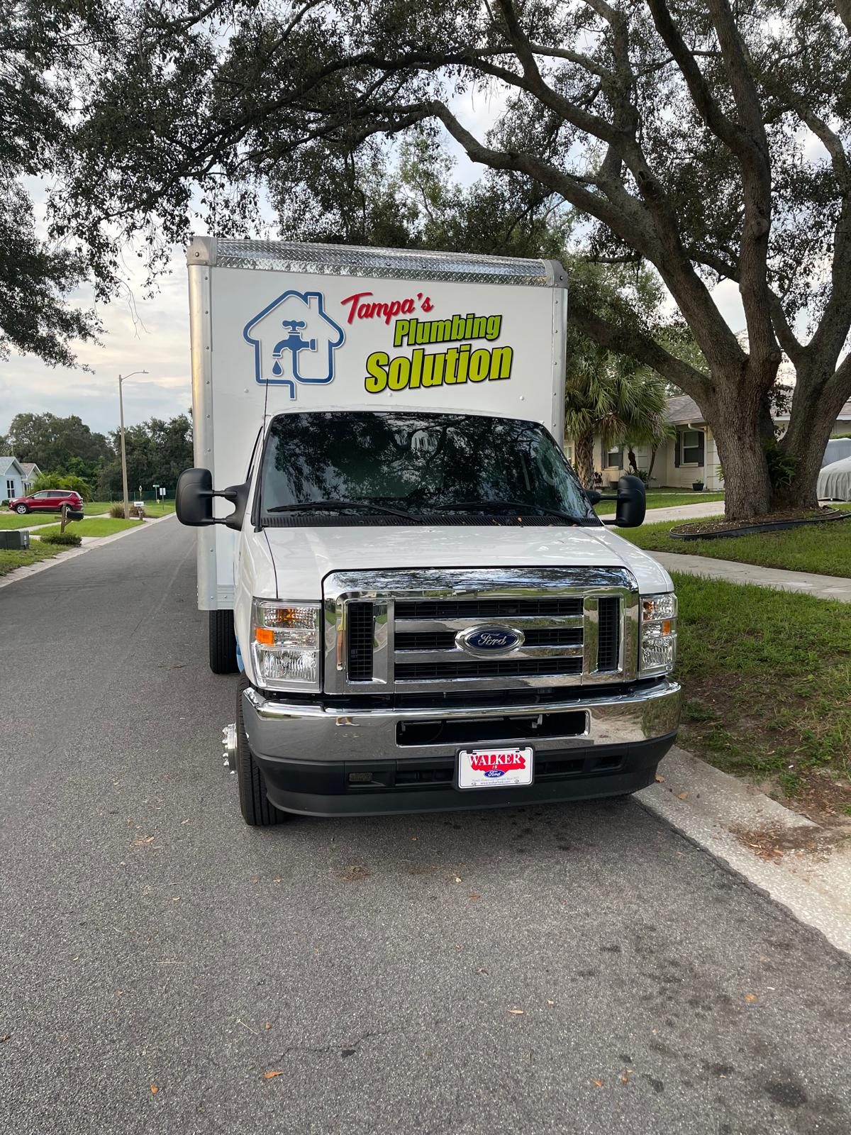 Tampa's Plumbing Solution box truck on neighborhood street